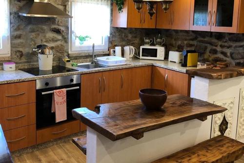 a kitchen with a wooden counter top with a bowl on it at Casas do Lobo in Tarouca