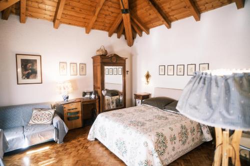 um quarto com uma cama e uma cadeira em Chalet Maso Pino em Castello Tesino