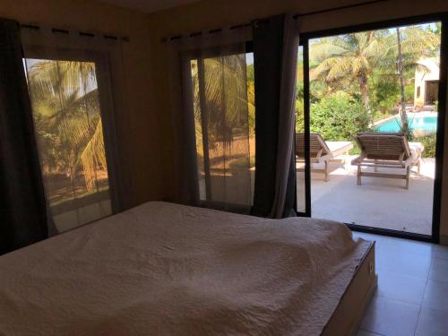 a bedroom with a bed and a sliding glass door at Villa L'Aldiana 