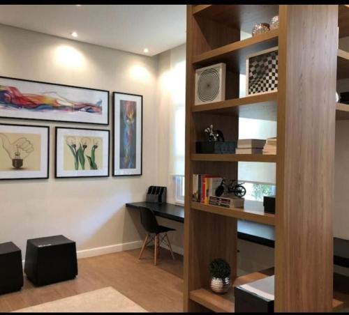 a room with a desk and a shelf with a computer at 1606 - Luxo e Conforto na Cidade Maia in Guarulhos