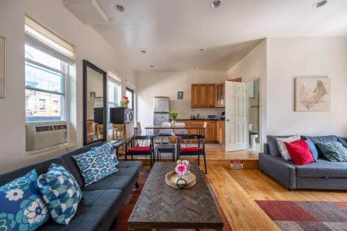 a living room with a couch and a table at East Village Townhouse in New York