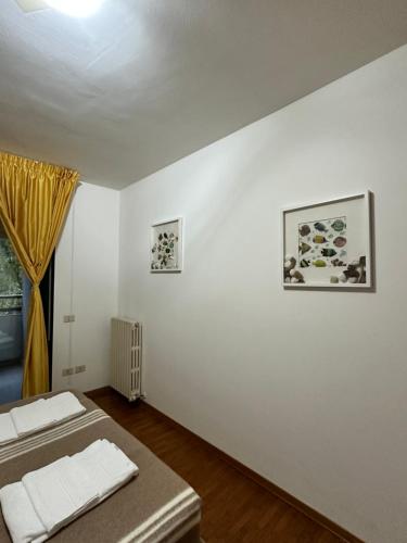 a white room with two beds and a window at Home Station Perugia in Perugia