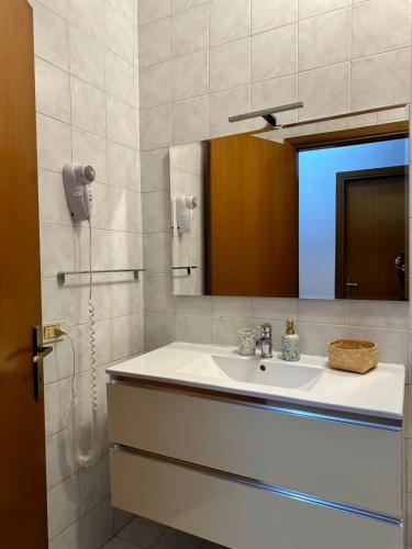 a bathroom with a sink and a mirror at Home Station Perugia in Perugia