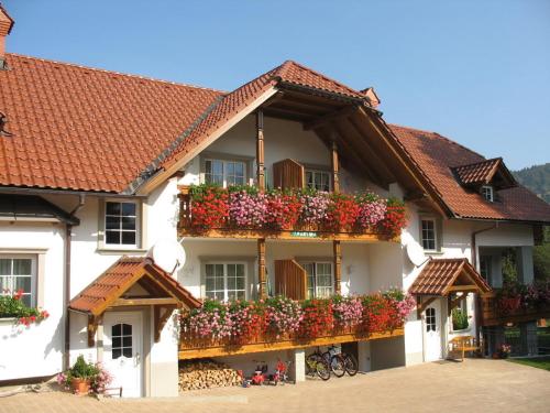 a building with flower boxes on its balconies at Apartments Timjana in Bohinj