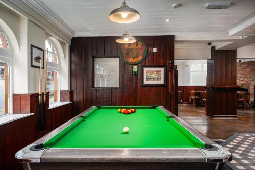 a billiard room with a green pool table at Elephant and Castle in Wakefield