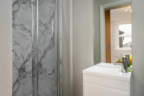 a bathroom with a shower and a sink and a mirror at Elephant and Castle in Wakefield