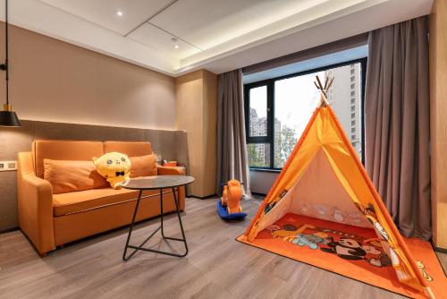 a living room with a couch and a tent at Atour X Hotel Harbin West Railway Station in Harbin