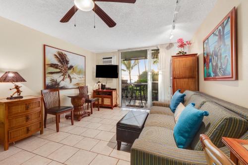 a living room with a couch and a tv at Kona Islander Inn 147 Tropical Oasis in Kailua-Kona