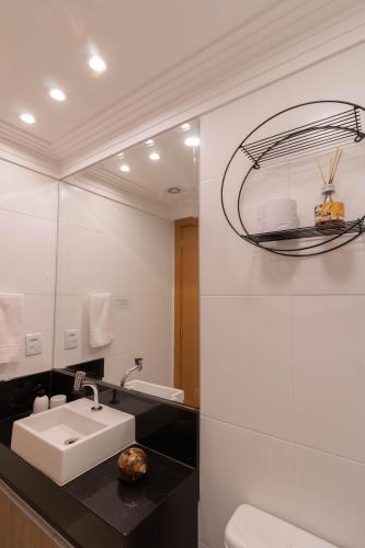a bathroom with a sink and a mirror at 0610 - Studio alto padrão in Guarulhos