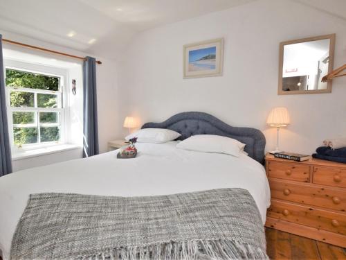 a bedroom with a large white bed and a window at 3 bed in Perranporth 57204 in Perranzabuloe
