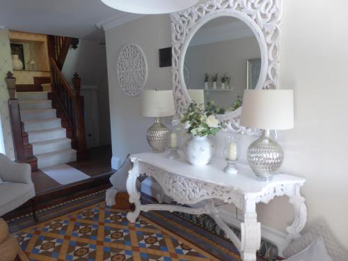 a living room with a table with a mirror at The Skreen in Builth Wells