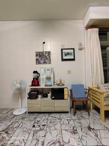 a living room with a counter with a microwave at Gods Home in Checheng