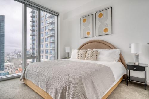 a bedroom with a bed and a large window at Rincon Hill 1BR w WD Gym Pool nr Tech HQs SFO-778 in San Francisco