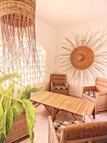 a room with a table and chairs and a sculpture at Ginger Villa Somone in Somone