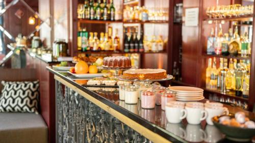 a bar with a counter with food and drinks at Boutique Hotel Soyka in Špindlerův Mlýn