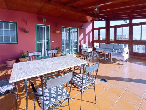 a room with a table and chairs and a couch at LIVE GUANCHES DE CANDELARIA in Candelaria