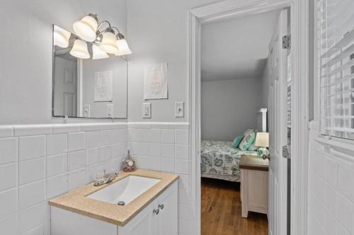 ein Badezimmer mit Waschbecken, Spiegel und Bett in der Unterkunft Fisher's Cove in Cape Carteret