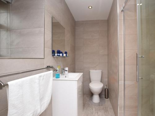 a bathroom with a toilet and a sink and a shower at 2 bed in Seamill 78991 in Ardrossan