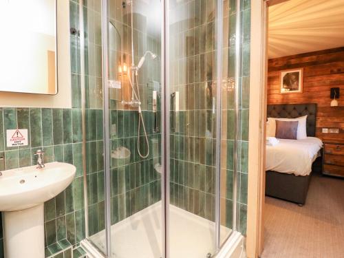 a bathroom with a shower and a sink at Eldroth in Skipton