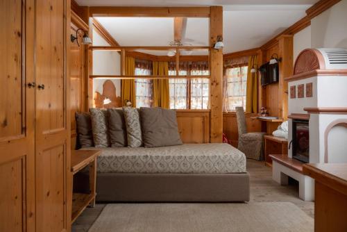 a living room with a couch in a room at Hotel Gianna in Madonna di Campiglio