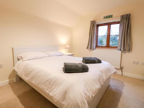 a bedroom with a bed with two pillows on it at Sunset View in Matlock