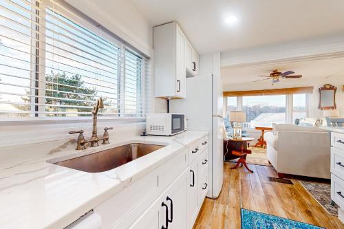 a kitchen with a sink and a microwave at Goat Hill Cottage in Beverly