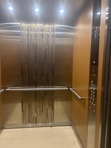 a glass elevator in a room with a ceiling at Bayfront Villa & Apartment in Portmore