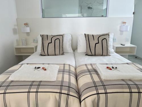 a bedroom with a bed with two towels on it at Paternoster Penthouse - Solar in Paternoster