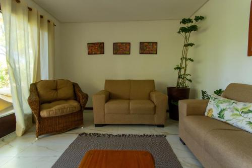 a living room with two chairs and a couch at Villa Botanic Garden in Itacaré