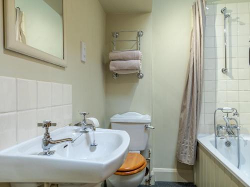 a bathroom with a sink and a toilet and a tub at 2 bed property in Axminster BLOOM in Axminster