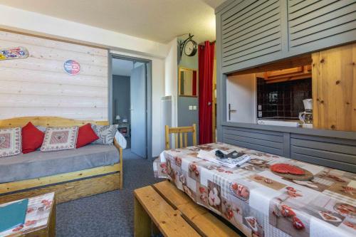 a bedroom with two beds and a table in it at T2 Tignes Val Claret in Tignes