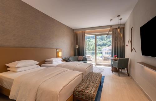 a hotel room with two beds and a television at Hyatt Regency Kotor Bay Resort in Kotor