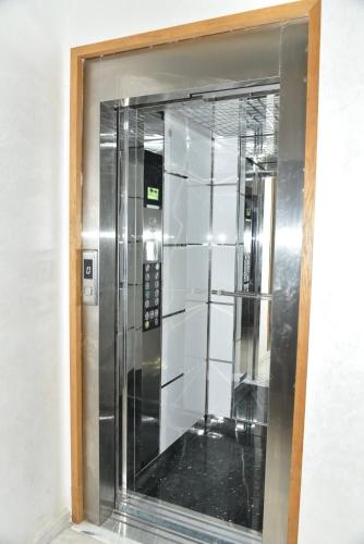 an elevator in a building with a glass window at Stylish 3-Bedroom Flat in Kenitra Center Ville with Parking & Comfort in Kenitra