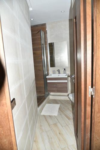 a bathroom with a shower and a sink at Stylish 3-Bedroom Flat in Kenitra Center Ville with Parking & Comfort in Kenitra