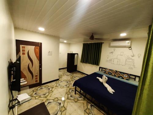een kamer met een bed met een teddybeer erop bij Ashirvad cottage in Alībāg
