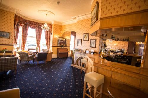 a room with a bar and a living room at Furzedown Hotel in Great Yarmouth