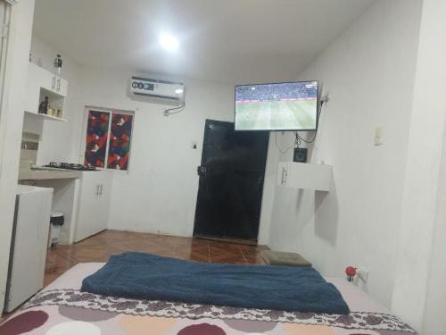 um quarto com uma cama e uma televisão de ecrã plano em Mini Suite em Manta