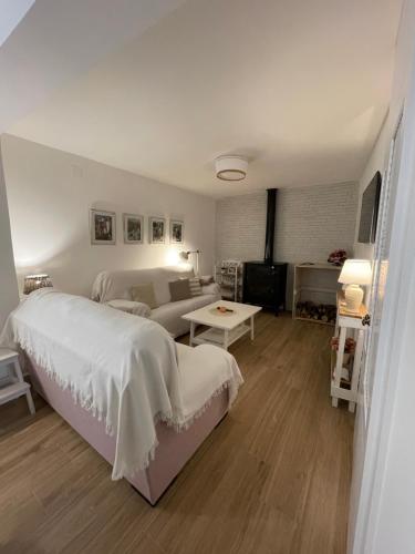 a bedroom with a bed and a living room at El rincón de la Yaya in Pampaneira