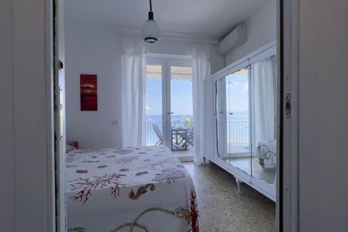 a bedroom with a bed and a view of the ocean at Villa Federigo - Monte Argentario in Monte Argentario