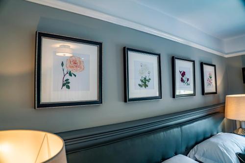 a room with four pictures of flowers on the wall at Mytton and Mermaid - Brunning and Price in Shrewsbury