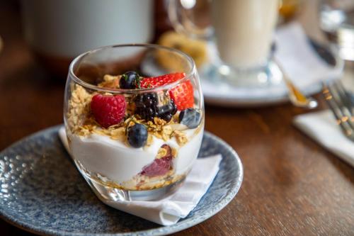 a dessert with berries and whipped cream on a plate at Mytton and Mermaid - Brunning and Price in Shrewsbury