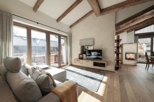 a living room with a couch and a tv at Alpine Lofts M26 in Grossarl
