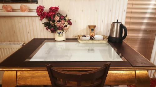 a kitchen counter with a sink with a coffee maker and flowers at Studio with Terrace Near Prague Airport 