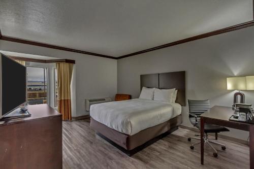 a hotel room with a bed and a desk at Park Inn by Radisson, Salt Lake City-Midvale in Midvale