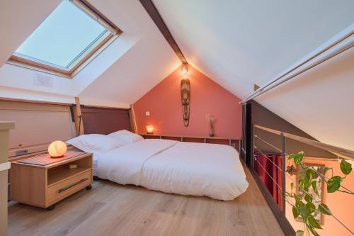 une chambre avec un grand lit et une fenêtre dans l'établissement Bel appartement, mezzanine, calme, 2 coins bureaux - Home'ponopono, à Nantes