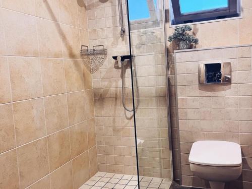 a bathroom with a shower with a toilet at New holiday homes near the sea in Niechorze in Niechorze