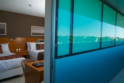 Katil atau katil-katil dalam bilik di Orfeo Suites Hotel Sierras Chicas