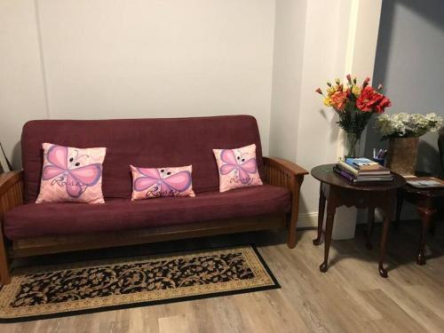 a purple couch with pink pillows and a table at CLARENDON,SUPRLOCATION,8ppl,PRIVATE,METRO,PARK in Arlington