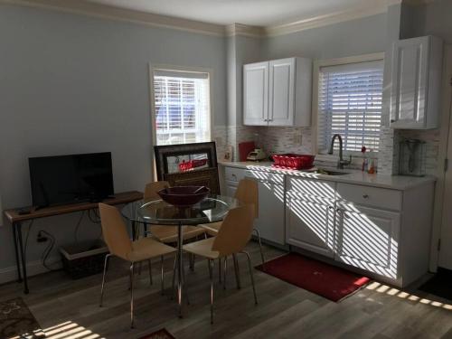 a kitchen with a glass table and chairs in a kitchen at CLARENDON,SUPRLOCATION,8ppl,PRIVATE,METRO,PARK in Arlington