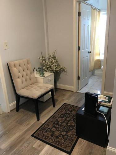 a living room with a chair and a table at CLARENDON,SUPRLOCATION,8ppl,PRIVATE,METRO,PARK in Arlington
